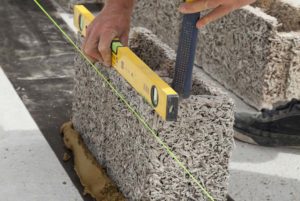 Photo of builder laying down an ICF unit