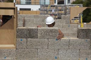 Construction worker building a wall using ICF units