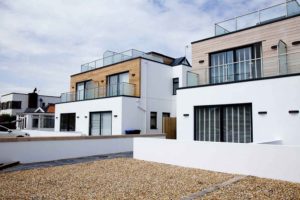 Photo of modern houses with wood cladding built with Durisol ICF