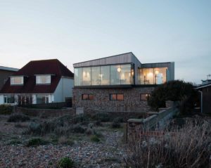 Exterior photo of contemporary self-build house using Durisol UK Insulated Concrete Form (ICF) units at sunset